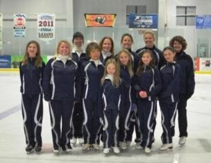 Figure staking staff in blue uniforms on ice rink