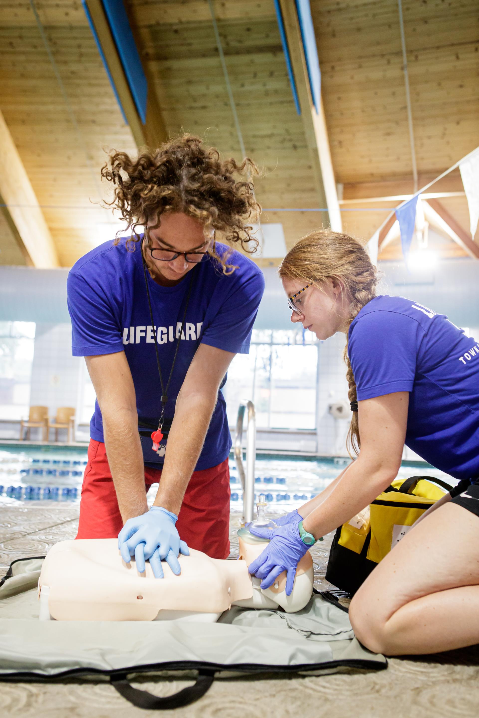 Two lifeguards working on CPR dummy