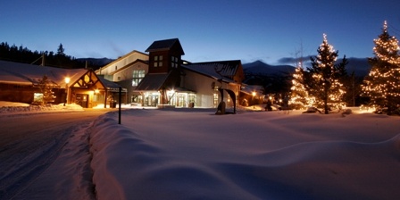 Winter evening exterior of Stephen C. West Ice Arena with lighted trees