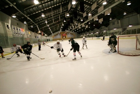 Wide view of hockey game at Stephen C. West Ice Arena