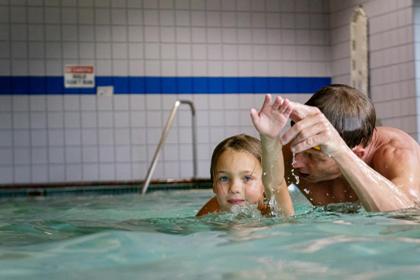 Child in swimming lesson with instructor