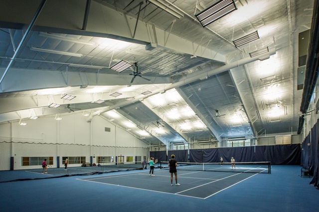 Women playing tennis indoors