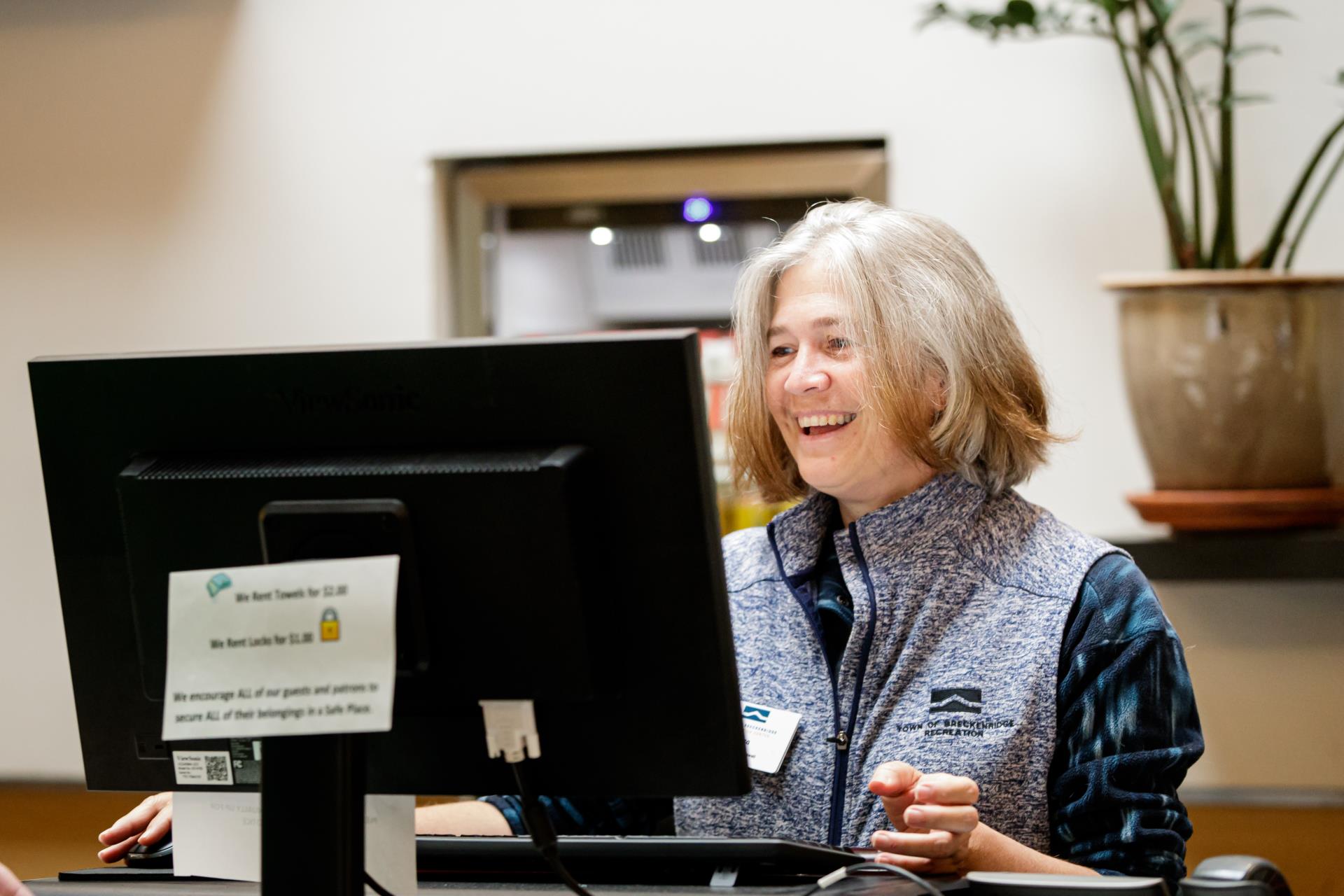 Recreation Center guest service agent at computer