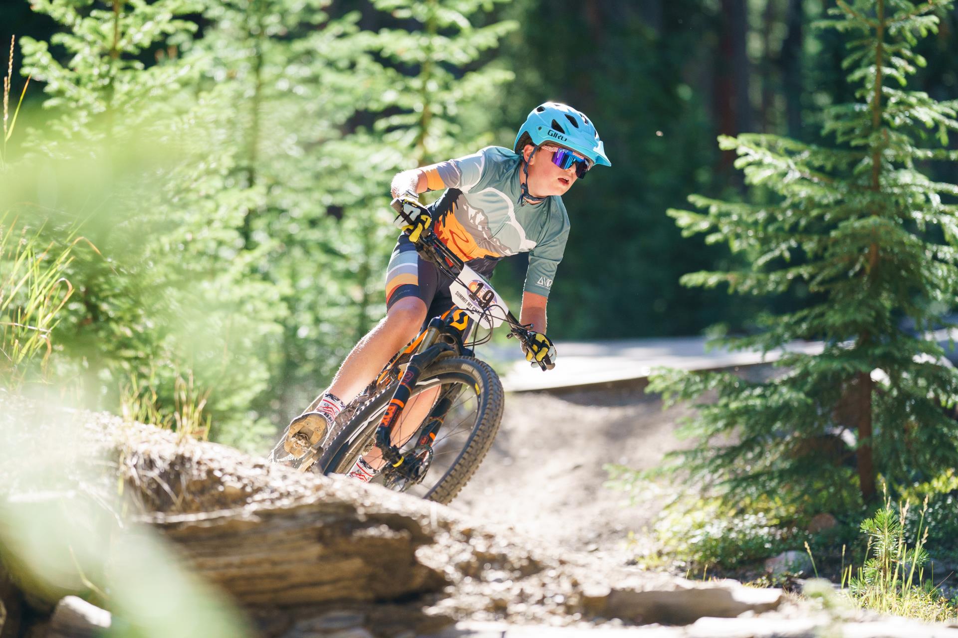 junior league rider on bike in blue helmet